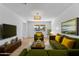 Bright living room with large sofa, stylish decor, and natural light creates a comfortable gathering space at 1642 E Turney Ave, Phoenix, AZ 85016