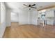 Spacious living room with wood floors, a ceiling fan, and an open kitchen at 1642 E Turney Ave, Phoenix, AZ 85016