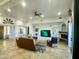 Expansive living room with travertine floors and built-in shelving with fireplace at 16538 E Desert Vista Trl, Scottsdale, AZ 85262