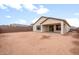 Exterior view of a large backyard surrounded by a privacy fence and covered patio at 16721 W Whispering Wind Dr, Surprise, AZ 85387
