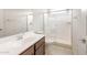 Bathroom features a vanity with a white countertop, undermount sink, and a glass-enclosed shower stall at 16721 W Whispering Wind Dr, Surprise, AZ 85387