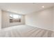 Bright bedroom with neutral carpet flooring and a large window at 16721 W Whispering Wind Dr, Surprise, AZ 85387