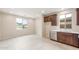Bright breakfast nook with tile floors, cabinetry, stainless dishwasher, sink and window views of the backyard at 16721 W Whispering Wind Dr, Surprise, AZ 85387