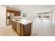 Modern open-concept kitchen features stainless steel appliances and a large island with a sink at 16721 W Whispering Wind Dr, Surprise, AZ 85387