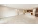 Open-concept living room and kitchen area features neutral tile flooring and recessed lighting at 16721 W Whispering Wind Dr, Surprise, AZ 85387