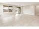 Bright and airy living room with large windows and sliding glass doors at 16721 W Whispering Wind Dr, Surprise, AZ 85387