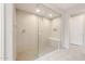 Modern shower features a built in shower bench, overhead shower head, and stylish tile at 16721 W Whispering Wind Dr, Surprise, AZ 85387