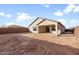 Home with a desert landscaped backyard and covered patio at 16735 W Whispering Wind Dr, Surprise, AZ 85387