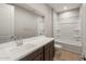 Bathroom featuring a single sink vanity with a white countertop and tub at 16735 W Whispering Wind Dr, Surprise, AZ 85387