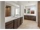 An expansive bathroom features dual vanities, a soaking tub, and a separate walk-in shower with neutral tiling at 16735 W Whispering Wind Dr, Surprise, AZ 85387
