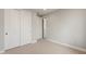 Bright bedroom with neutral carpet, ample closet space, and a view to the hallway at 16735 W Whispering Wind Dr, Surprise, AZ 85387