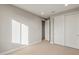 Bedroom with carpet, closet with sliding doors, and white trim at 16735 W Whispering Wind Dr, Surprise, AZ 85387