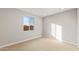 Neutral bedroom with carpet, white trim, and a window with a view at 16735 W Whispering Wind Dr, Surprise, AZ 85387