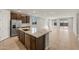 Open-concept kitchen with a large island, stainless steel appliances, and tile flooring at 16735 W Whispering Wind Dr, Surprise, AZ 85387