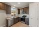 Well-equipped kitchen with stainless steel appliances, granite countertops, and stylish dark cabinetry at 16735 W Whispering Wind Dr, Surprise, AZ 85387