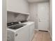 Laundry room featuring washer and dryer with tile floor at 16735 W Whispering Wind Dr, Surprise, AZ 85387