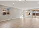 A spacious living room featuring tile flooring, recessed lighting, and multiple windows for plenty of natural light at 16735 W Whispering Wind Dr, Surprise, AZ 85387