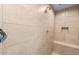 Tiled shower features bench, recessed shelf, and rainfall shower head at 16735 W Whispering Wind Dr, Surprise, AZ 85387