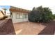 Backyard features desert landscaping, privacy wall and patio area with mature landscaping and shade at 1699 Leisure World --, Mesa, AZ 85206