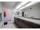 A bathroom with a dual sink vanity and a large mirror, in addition to a walk-in shower and separate toilet area at 1699 Leisure World --, Mesa, AZ 85206