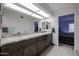 A bathroom with a dual sink vanity and a large mirror, in addition to a walk-in shower and separate toilet area at 1699 Leisure World --, Mesa, AZ 85206