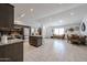 Bright open kitchen with granite countertops, stainless steel appliances, and large tile flooring at 1699 Leisure World --, Mesa, AZ 85206