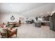 Bright open-concept living space with kitchen island, dining area, and wicker furniture set at 1699 Leisure World --, Mesa, AZ 85206