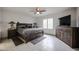 This spacious main bedroom offers a ceiling fan, neutral paint, plantation shutters and tile flooring at 1699 Leisure World --, Mesa, AZ 85206