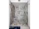 The walk-in shower is encased with decorative stone, a shower caddy and rain shower fixture at 1699 Leisure World --, Mesa, AZ 85206