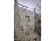 Stylish shower featuring designer gray tiled walls and a built-in shelf at 1699 Leisure World --, Mesa, AZ 85206