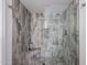 The walk-in shower is encased with decorative stone, a shower caddy and rain shower fixture at 1699 Leisure World --, Mesa, AZ 85206