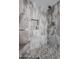 The walk-in shower is encased with decorative stone, a shower caddy and rain shower fixture at 1699 Leisure World --, Mesa, AZ 85206