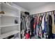A large walk-in closet with shelving and rods to hang clothes and store personal items at 1699 Leisure World --, Mesa, AZ 85206