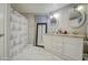 Bright double vanity with a standing mirror and patterned shower curtains at 17841 N 20Th St, Phoenix, AZ 85022