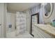 Bathroom featuring shower/tub combo with gray and white curtain, large mirror and vanity at 17841 N 20Th St, Phoenix, AZ 85022