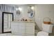 Bright bathroom with granite countertop and and sinks, and commode with basket on top at 17841 N 20Th St, Phoenix, AZ 85022