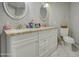 Bright bathroom with granite countertop and and sinks, and commode with basket on top at 17841 N 20Th St, Phoenix, AZ 85022