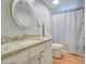 Bright bathroom features a vanity with granite countertop and shower with patterned curtain at 17841 N 20Th St, Phoenix, AZ 85022