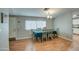 Traditional dining room with laminate floors, a modern chandelier, and large window at 17841 N 20Th St, Phoenix, AZ 85022