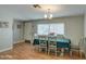 Traditional dining room with laminate floors, a modern chandelier, and large window at 17841 N 20Th St, Phoenix, AZ 85022