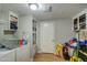The laundry room has vinyl flooring, built-in shelves, and a washer/dryer at 17841 N 20Th St, Phoenix, AZ 85022