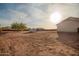 Expansive desert backyard with a metal storage shed, gazebo, and distant mountain views at 1819 W Joy Ranch Rd, Phoenix, AZ 85086