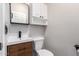 Stylish half bathroom featuring modern vanity, wooden drawers, a sleek mirror, and a toilet at 1819 W Joy Ranch Rd, Phoenix, AZ 85086