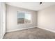 Bedroom with neutral colored walls, carpet and window overlooking an outdoor view at 1819 W Joy Ranch Rd, Phoenix, AZ 85086