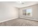 Bedroom with neutral colored walls, carpet and a bright window showcasing an outdoor view at 1819 W Joy Ranch Rd, Phoenix, AZ 85086