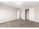 Bedroom with neutral walls and carpet featuring an open closet with doors and adjoining rooms at 1819 W Joy Ranch Rd, Phoenix, AZ 85086