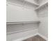 Bright, walk-in closet with white shelving and plenty of space for organization and storage at 1819 W Joy Ranch Rd, Phoenix, AZ 85086