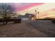A desert home with a two car garage and gravel landscaping at 1819 W Joy Ranch Rd, Phoenix, AZ 85086