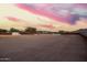 A view of the desert landscape, with a gazebo and storage shed enclosed by the property's wooden perimeter fence at 1819 W Joy Ranch Rd, Phoenix, AZ 85086