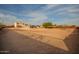 A view of the property showcasing a home with a gazebo, storage shed, and desert landscape at 1819 W Joy Ranch Rd, Phoenix, AZ 85086